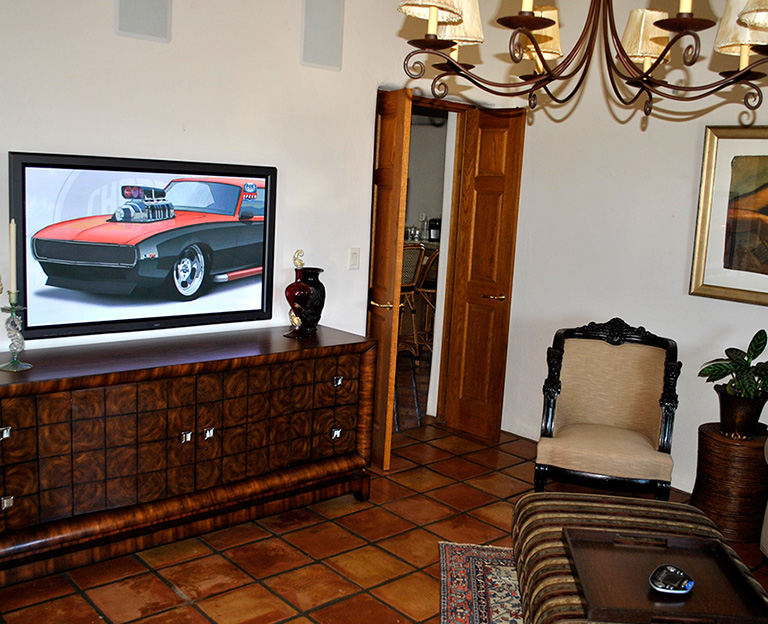 Flat screen TV mounted on credenza in Arizona home