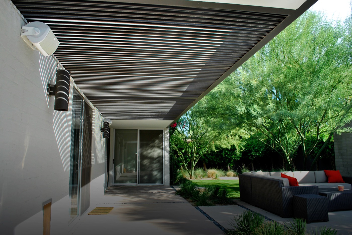 Outdoor patio with mounted speakers and audio system