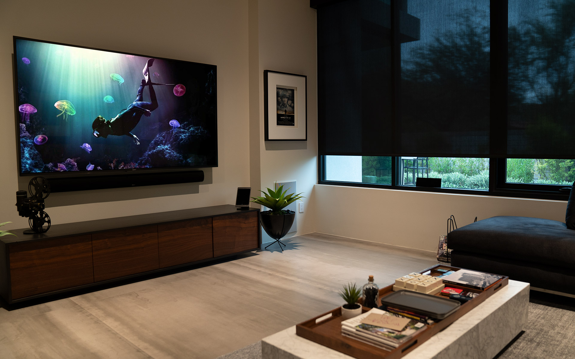 Home theater room with large wall-mounted TV and soundbar